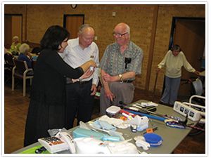 therapist showing different products to people at community 
talk