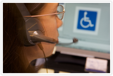 client services team member with 
headset staring at computer screen