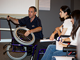 trainer demonstrating features of a 
wheelchair