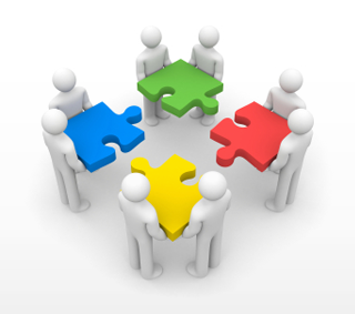 people coming together with separate pieces to complete puzzle